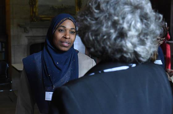 Photo of two women speaking at a poster presentation event